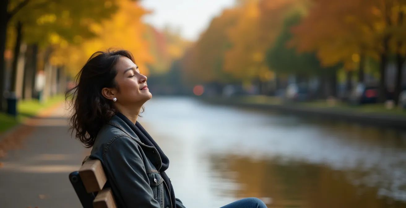 Person relaxing by Rideau Canal pathway during golden hour in Ottawa